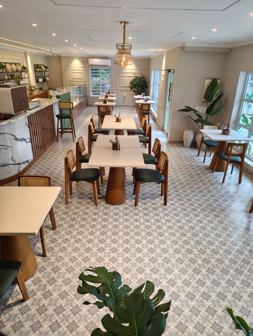 Free Chic and contemporary cafe interior featuring minimalist design and natural light in Thrissur, India. Stock Photo