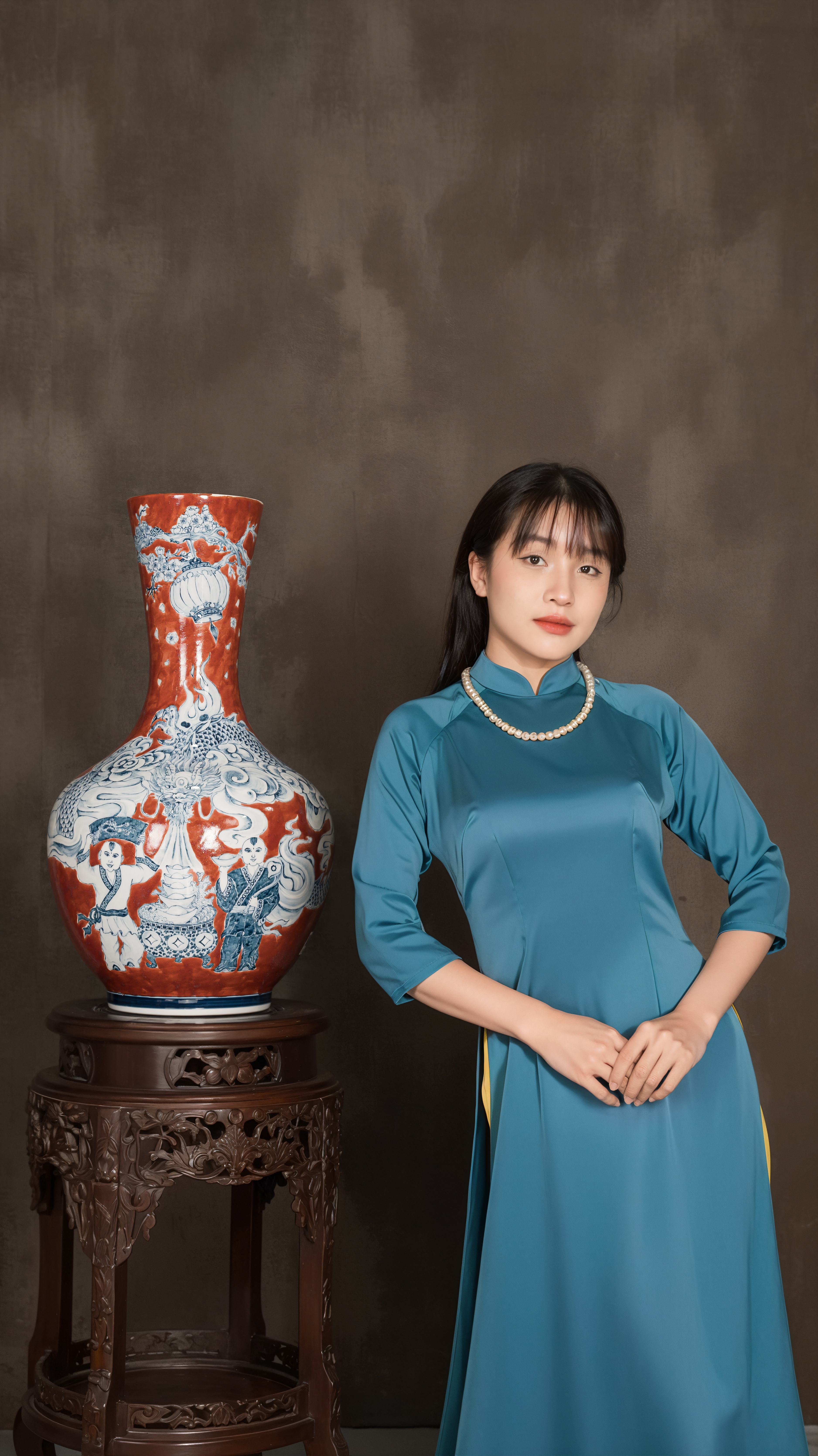 Portrait of an Asian woman dressed in traditional attire standing next to an ornate ceramic vase.