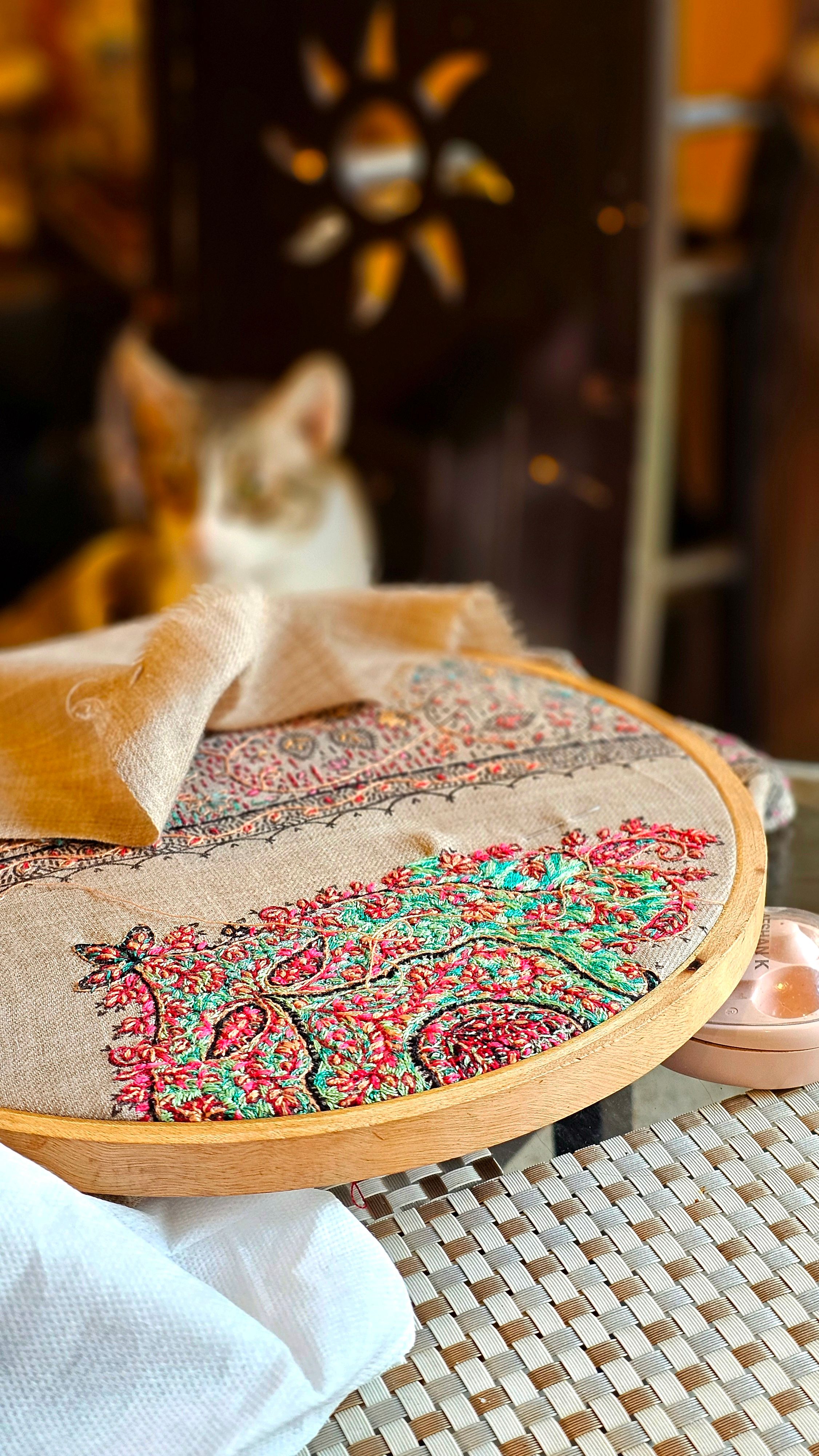 Colorful finished embroidery hoop displaying an artisan punch needle design