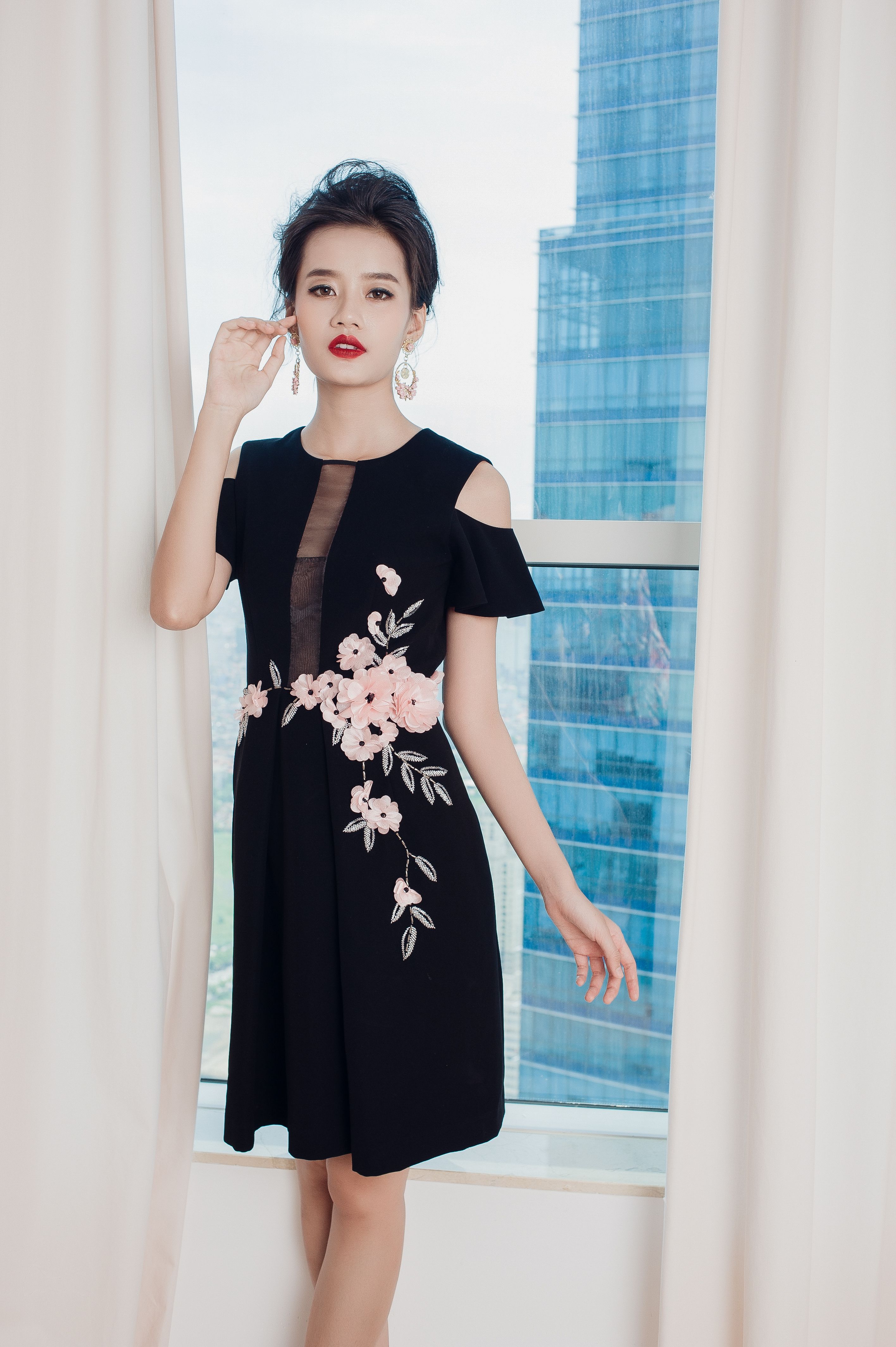 Elegant Woman Posing in Floral Embellished Dress · Free Stock Photo