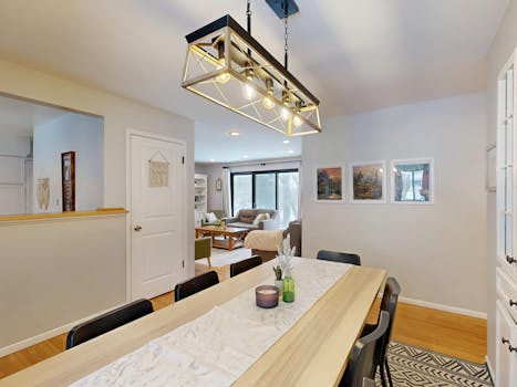 Well-lit modern dining area with contemporary decor and open living space.