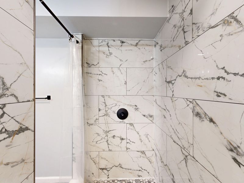 Hillsborough — luxurious walk-in shower with white and grey marble tile, minimal design