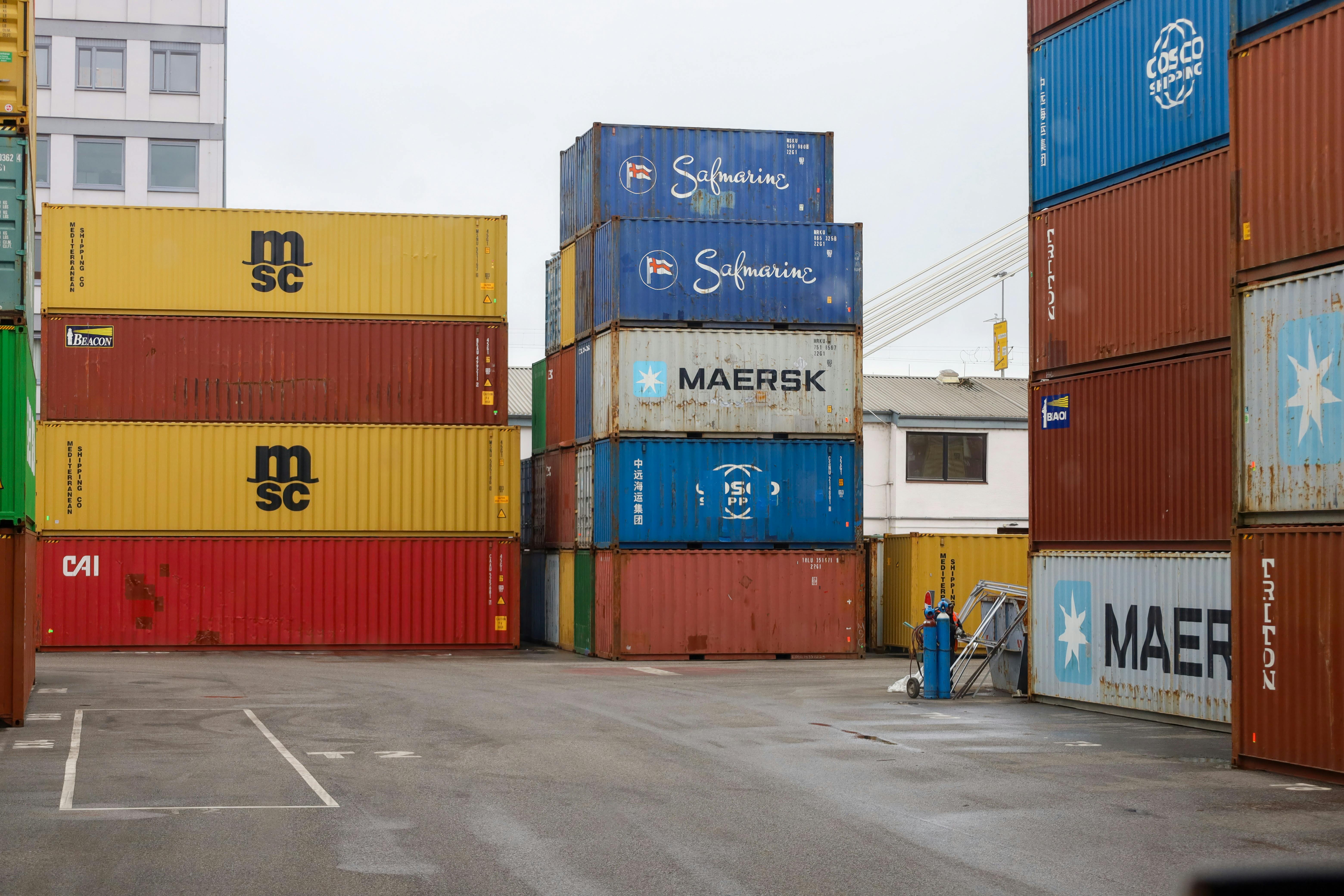 Stacked shipping containers in a port showcasing global trade logistics.