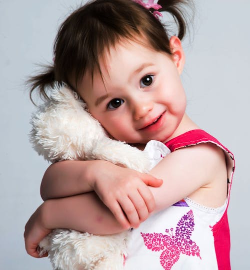Girl Hugging Plush Toy