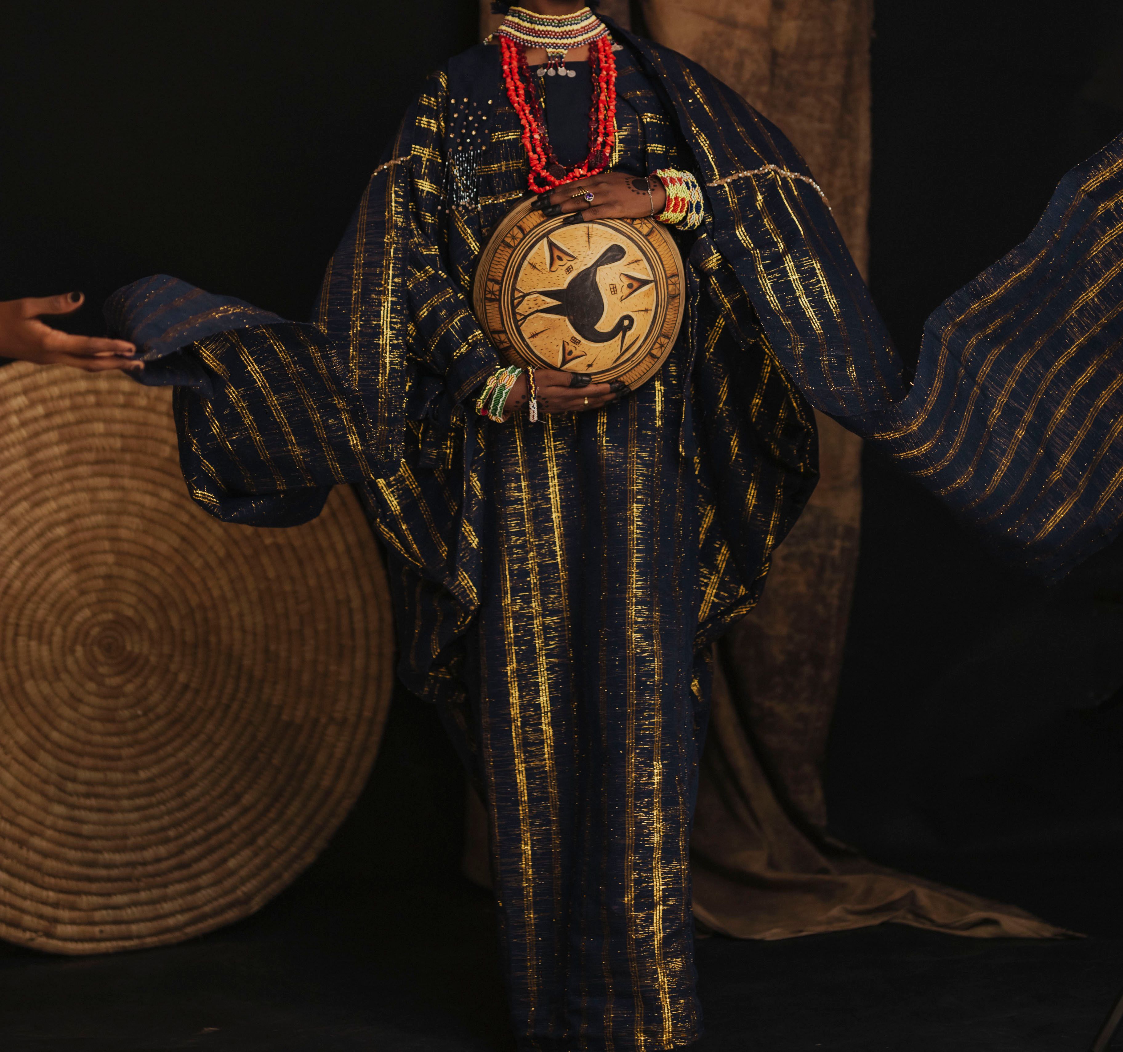 Colorful African robe and drum showcasing cultural heritage indoors.