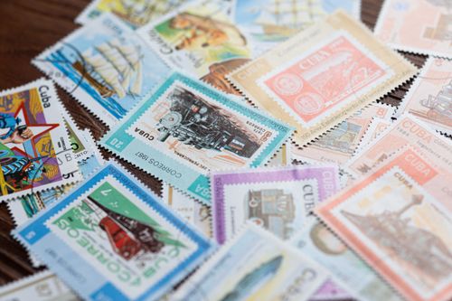 Free An artistic display of colorful vintage Cuban postage stamps showcasing various themes and designs. Stock Photo