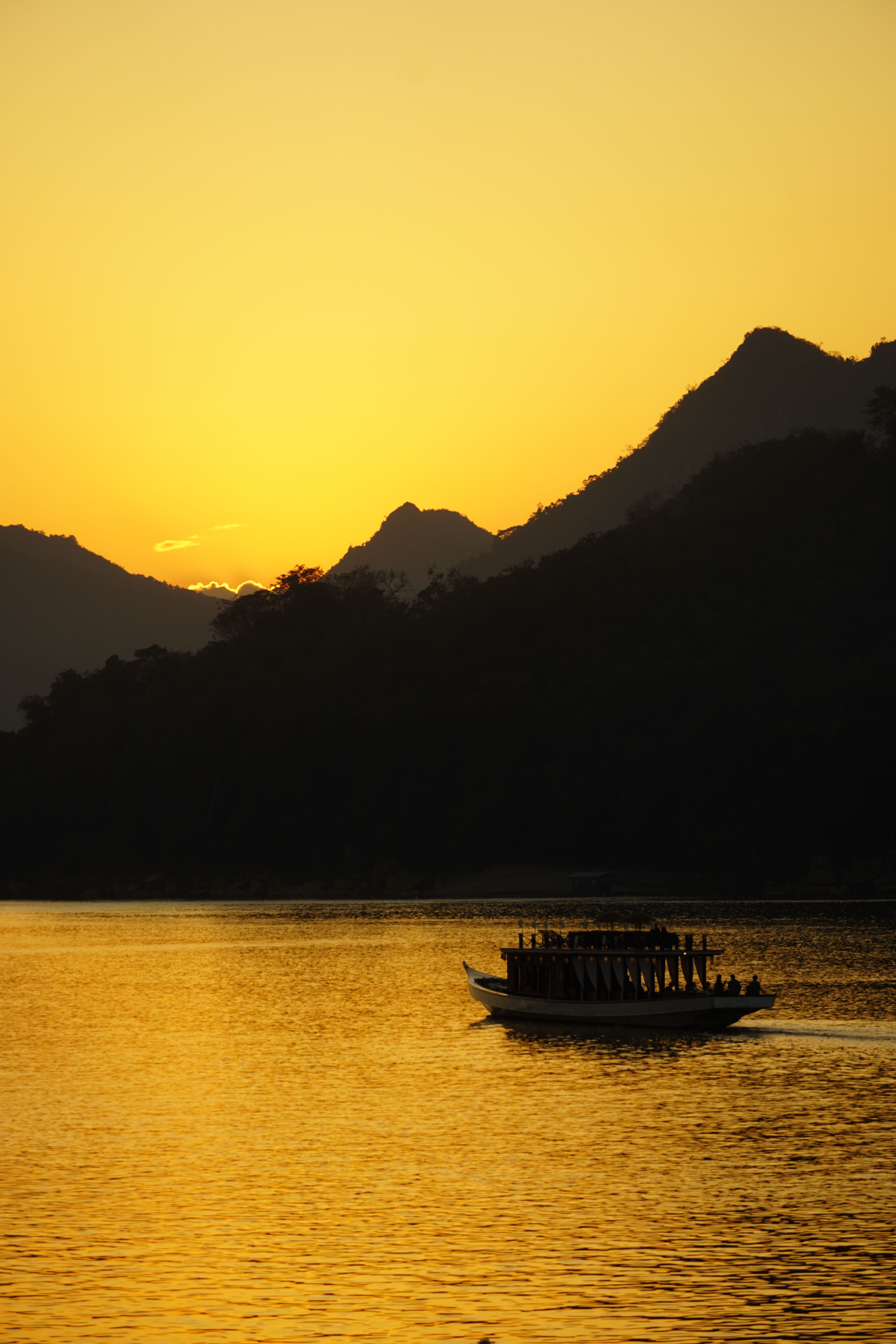 Silhouette of Boat on Lake at Sunset · Free Stock Photo