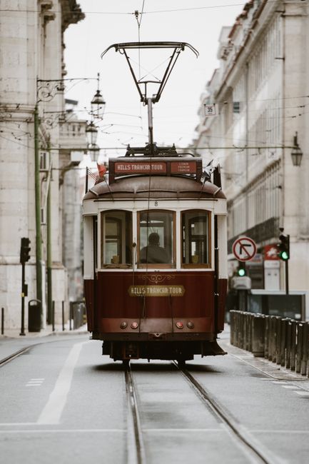 Charming vintage tram navigating the historic streets of Lisbon, Portugal. Captures the essence of Portuguese architecture.