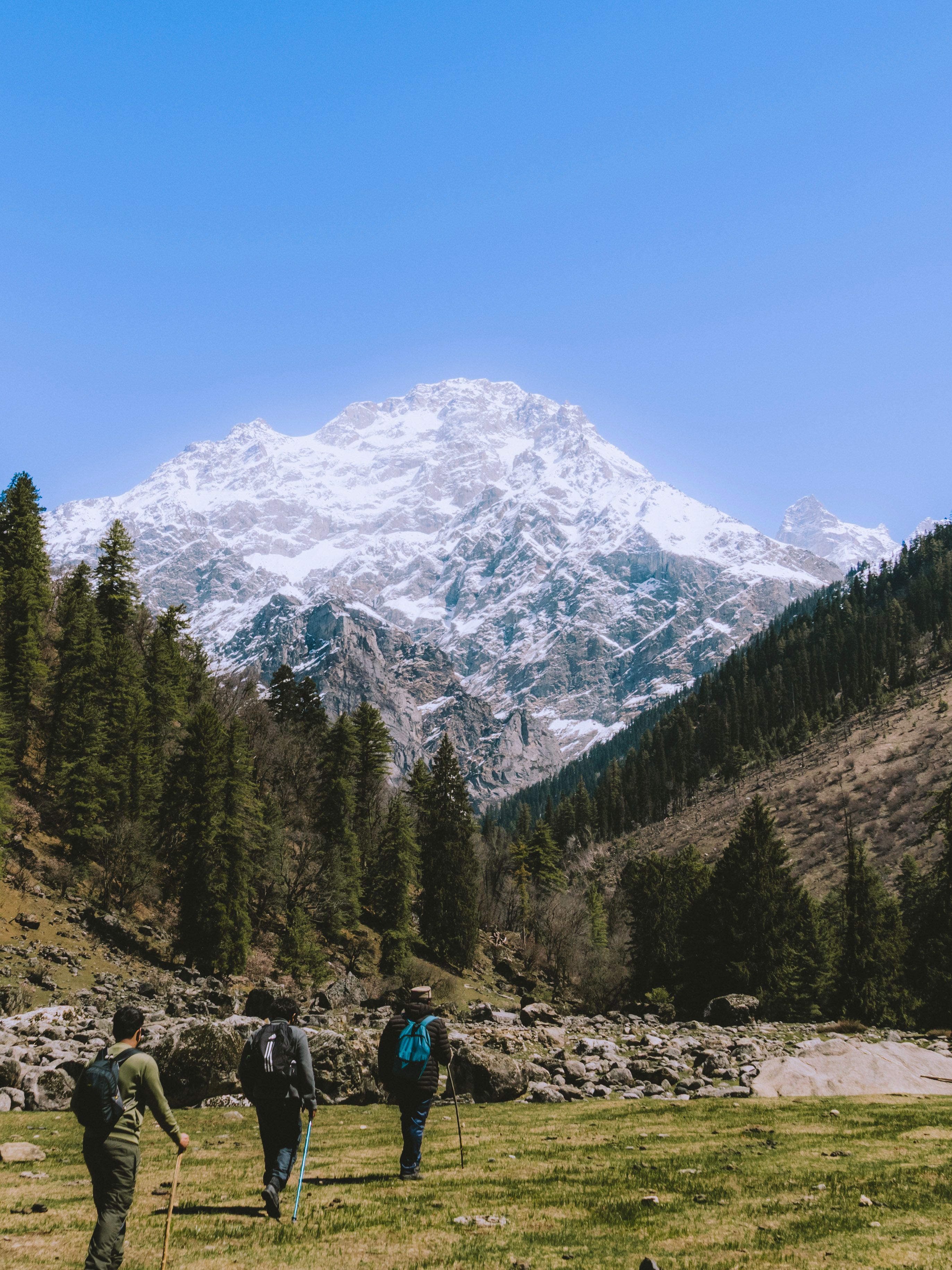 Hikers Exploring Scenic Mountain Landscape · Free Stock Photo