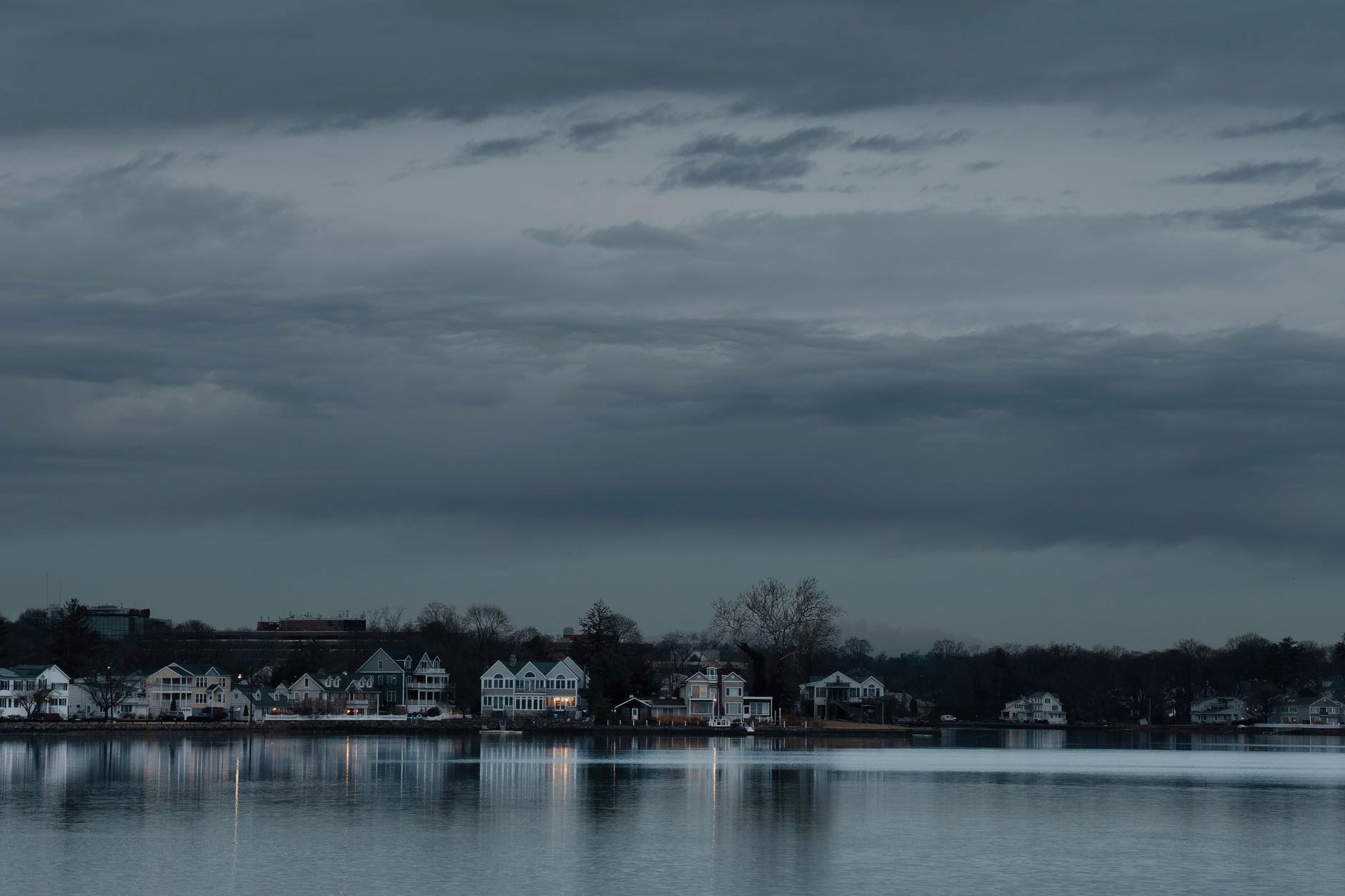 Serene dawn view of Stamford, Connecticut skyline reflecting on the water. Calm and tranquil atmosphere.