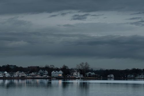 Free Serene dawn view of Stamford, Connecticut skyline reflecting on the water. Calm and tranquil atmosphere. Stock Photo