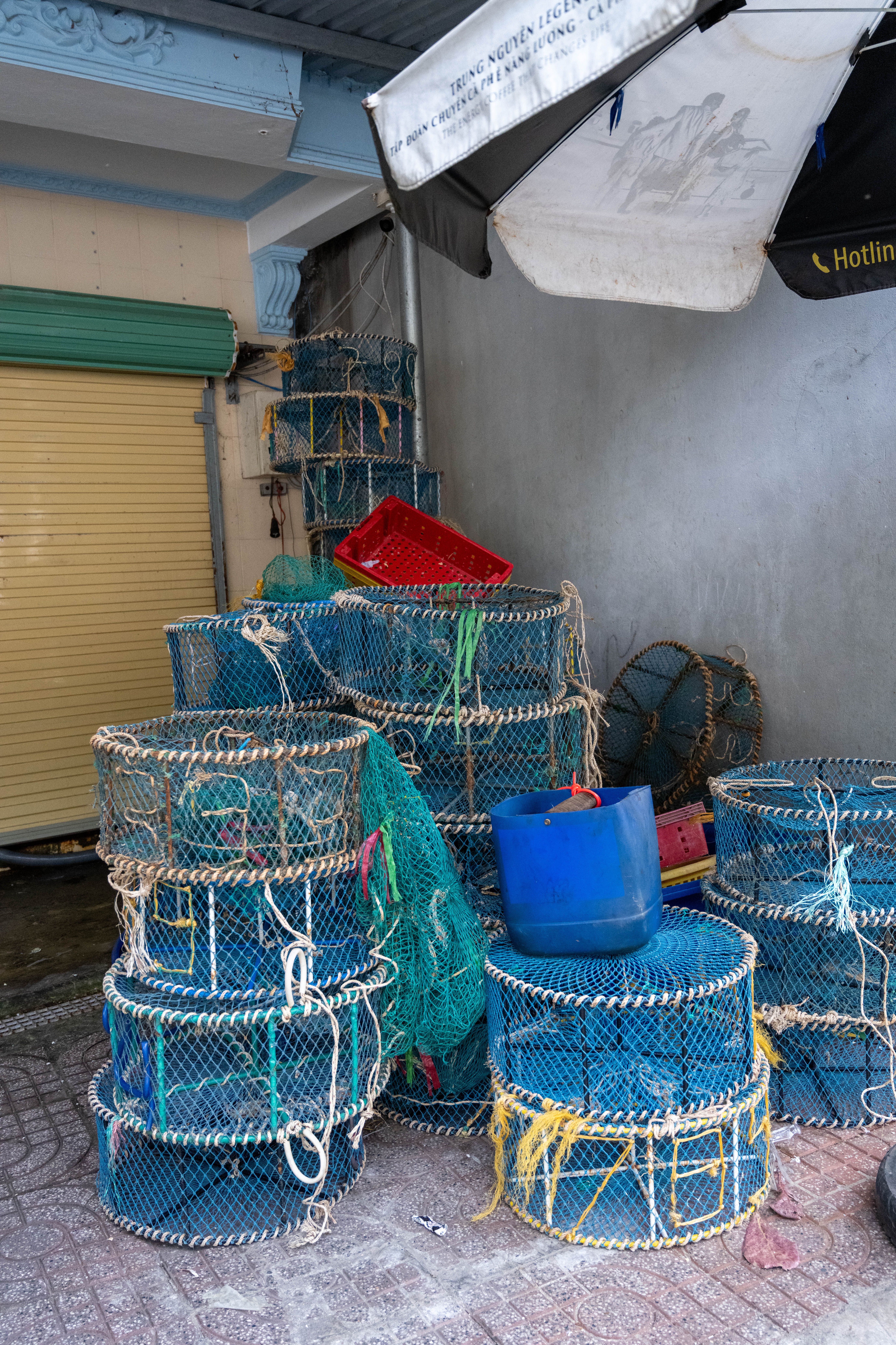 Vibrant fishing baskets stacked in a Vũng Tàu market, Vietnam.