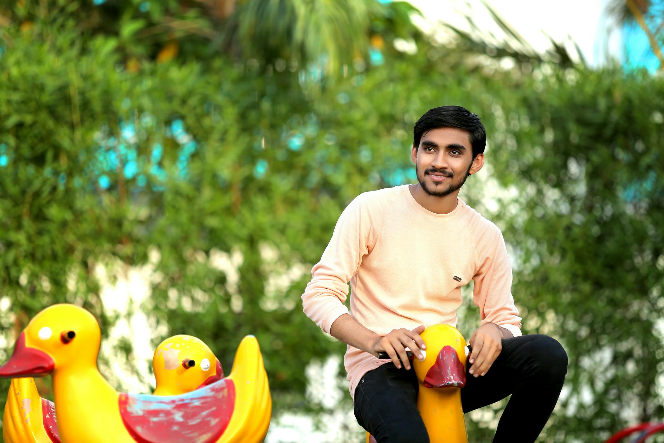 A close up of a hand coloring a detailed page in a coloring book