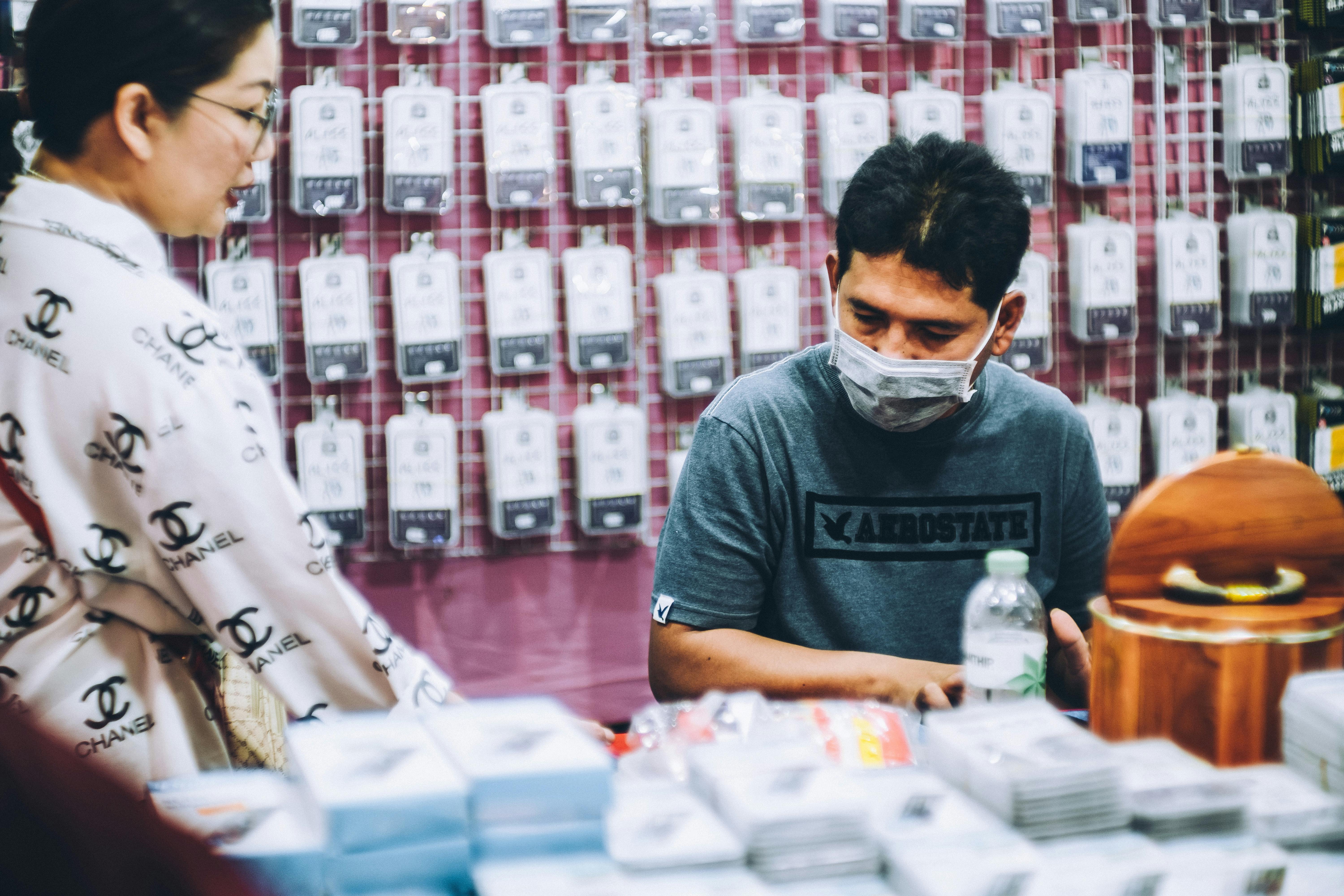 male worker talking to woman in shop