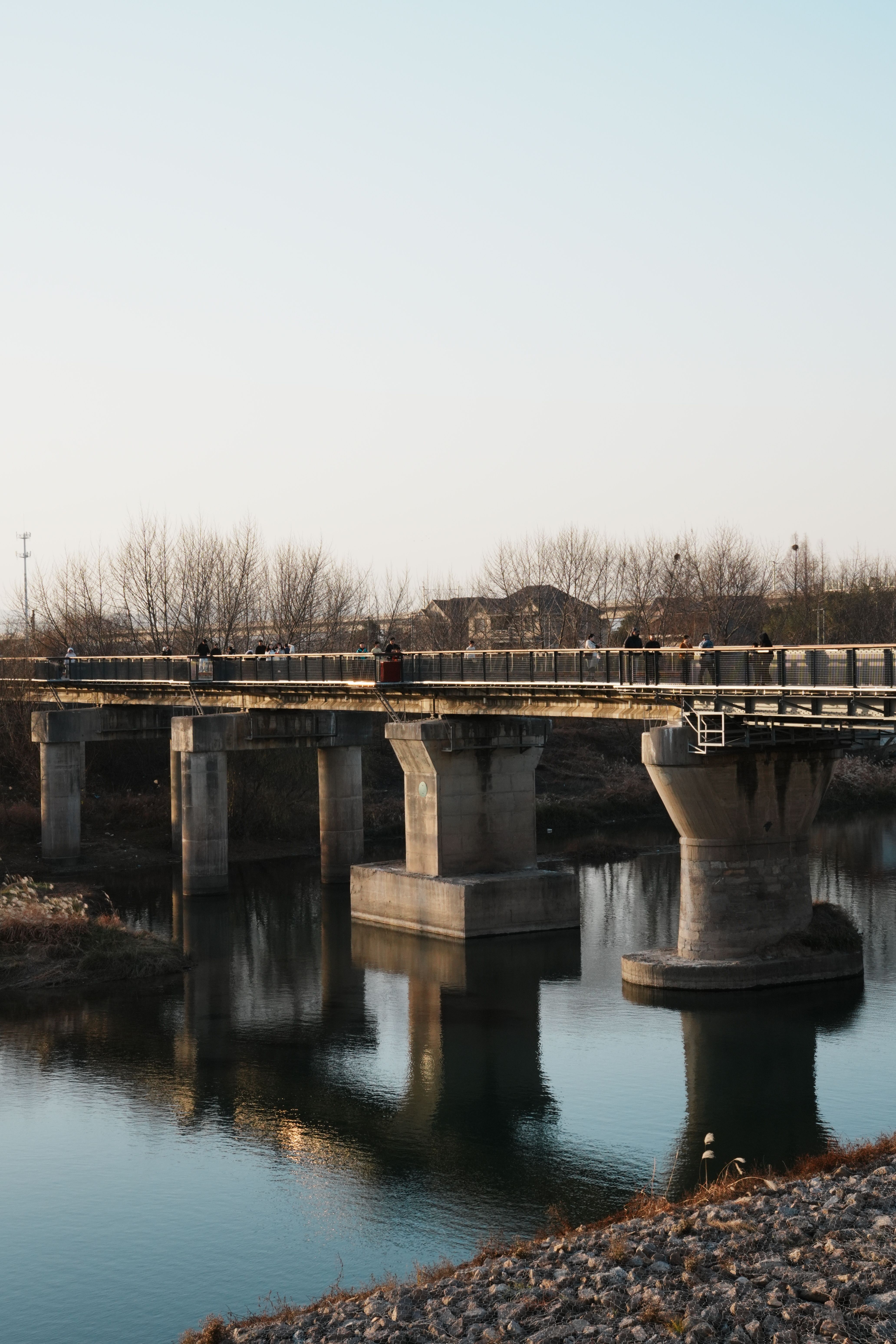 Scenic View of Abandoned Bridge Over Calm River · Free Stock Photo