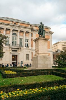 Statue and Museo del Prado facade in Madrid, ideal for cultural and travel content.