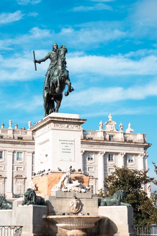 Free Equestrian statue of Philip IV near Royal Palace in Madrid under a clear blue sky. Stock Photo