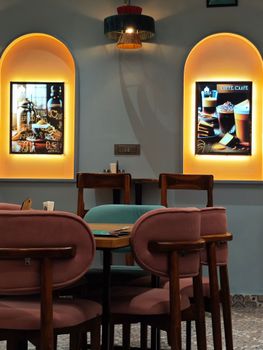 Stylish café interior with warm lighting and minimalist decor in Mathura, India.