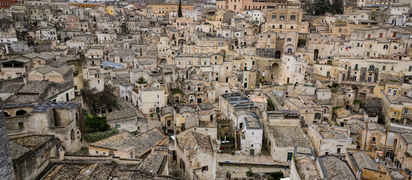Aerial view of the ancient stone buildings in Matera, showcasing historic Italian architecture.