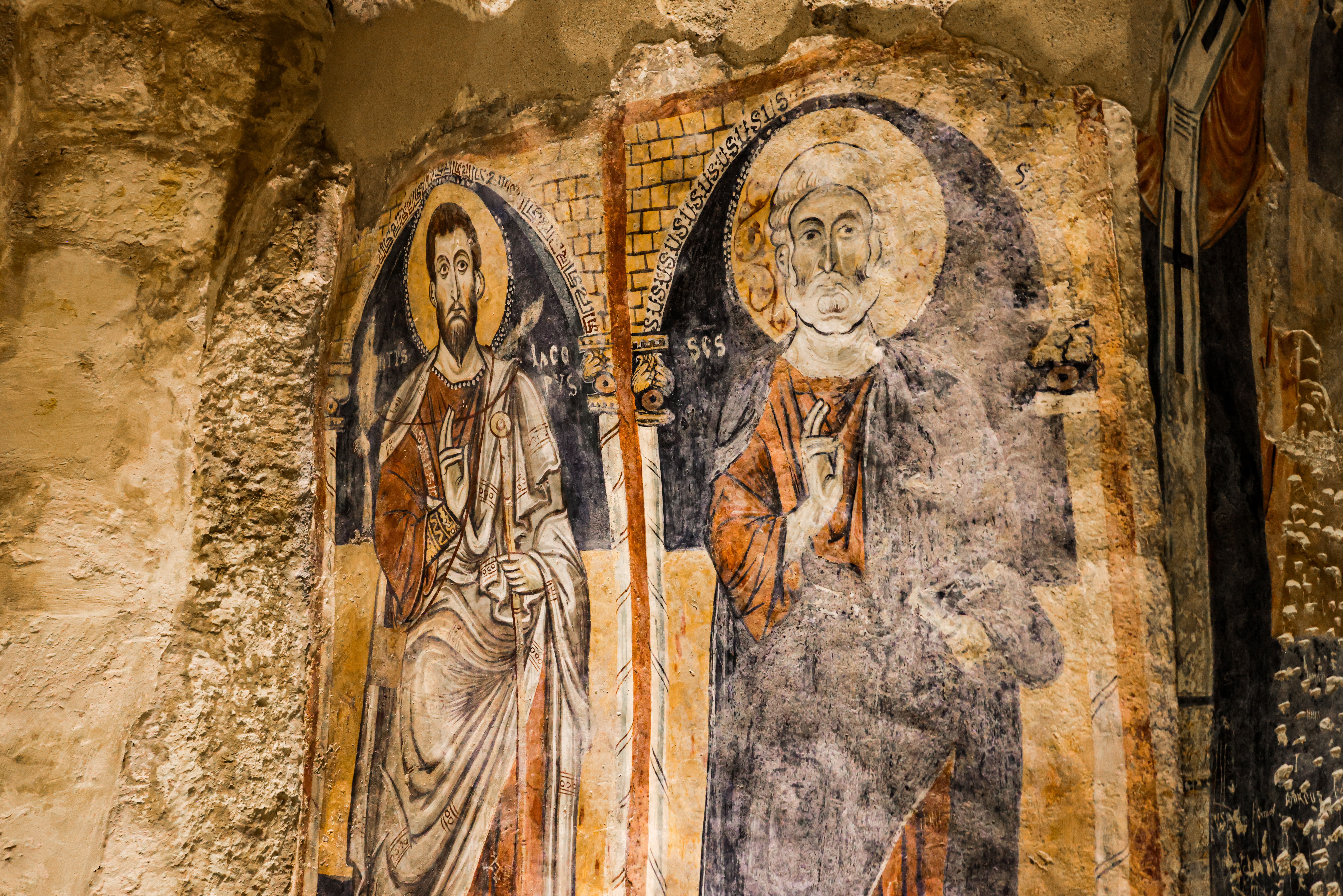 Detailed frescoes in ancient Roman architecture, showcasing historical religious art.