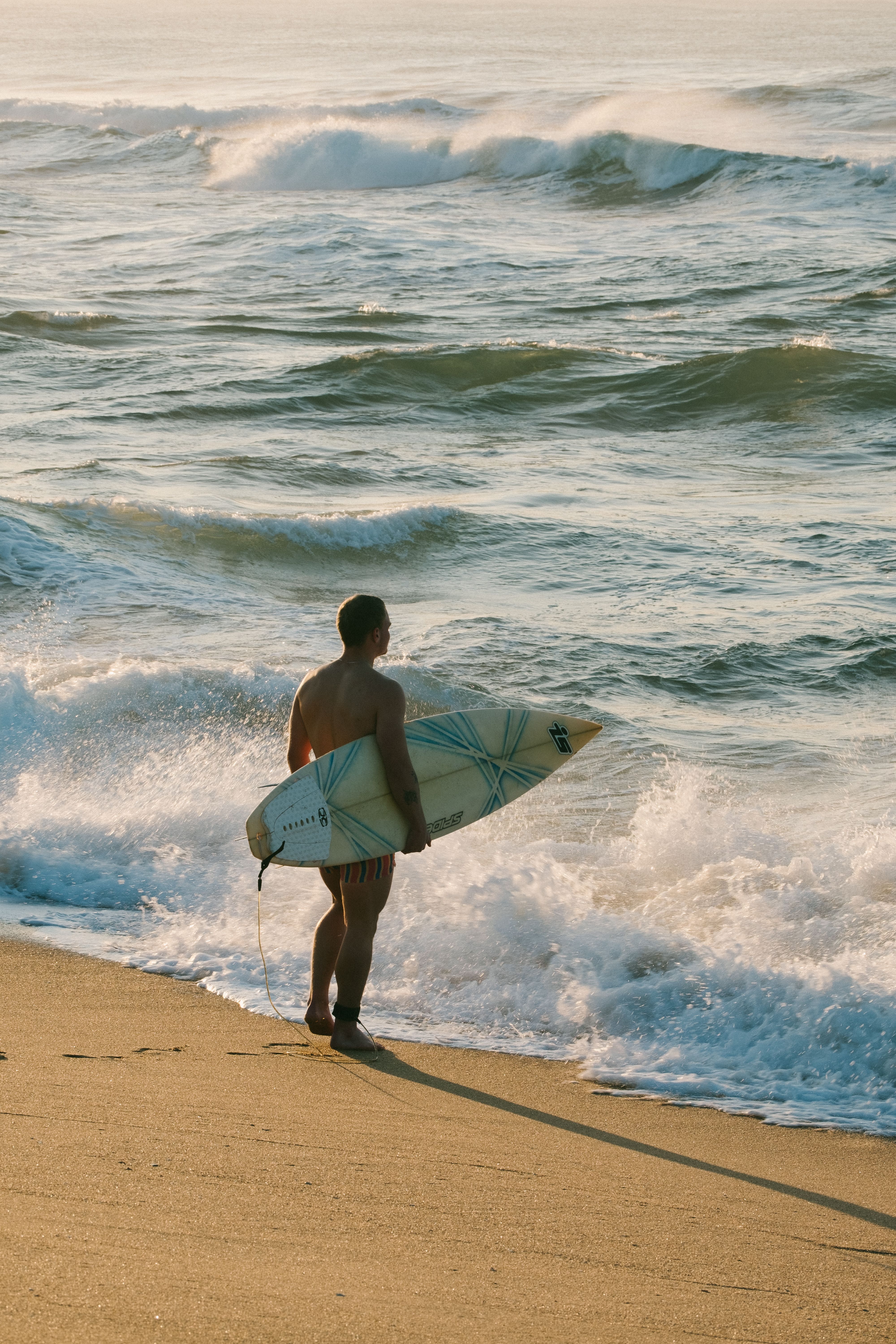 Surfer holding a surfboard on a Durban beach