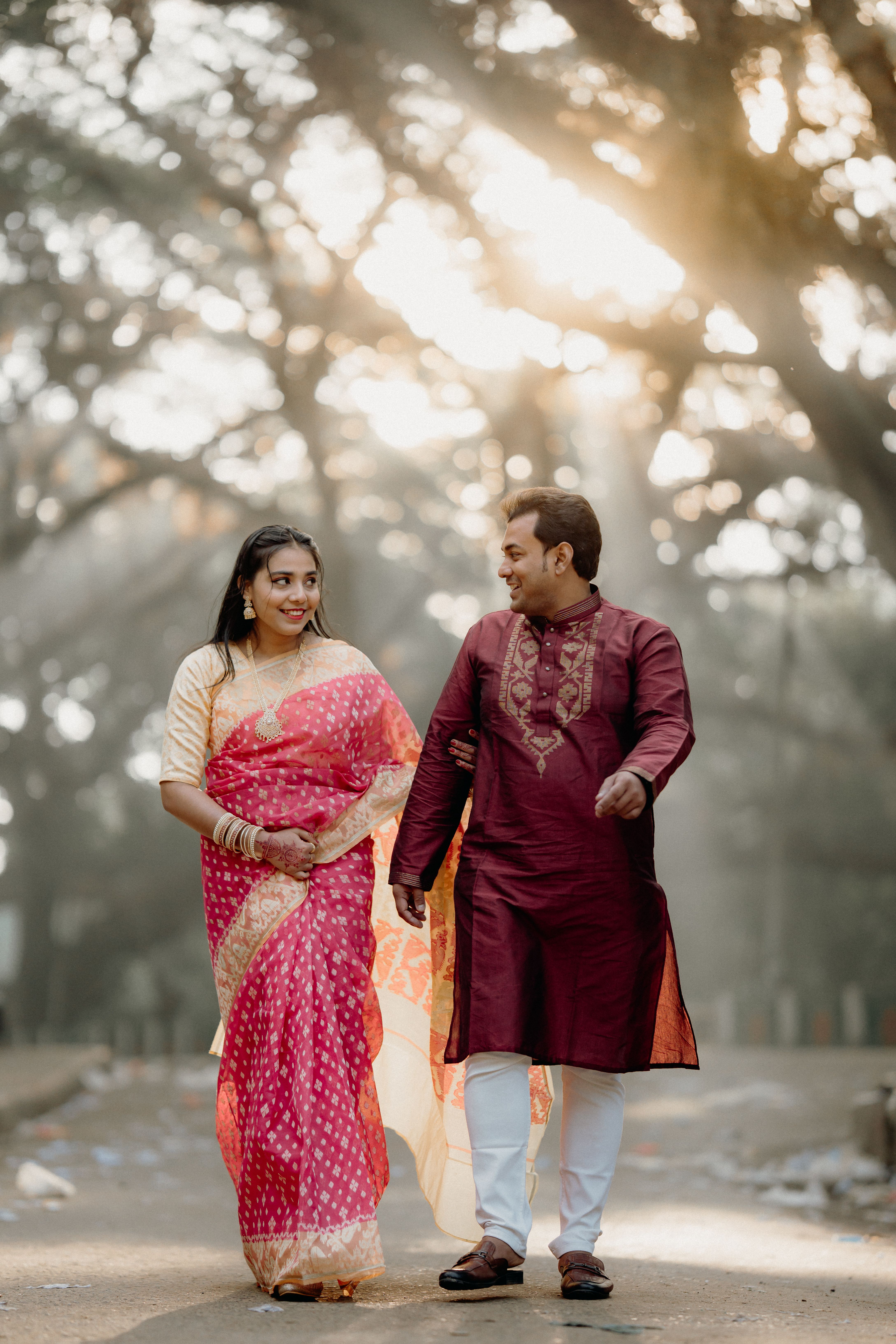 Couple in Traditional Attire Walking Outdoors · Free Stock Photo