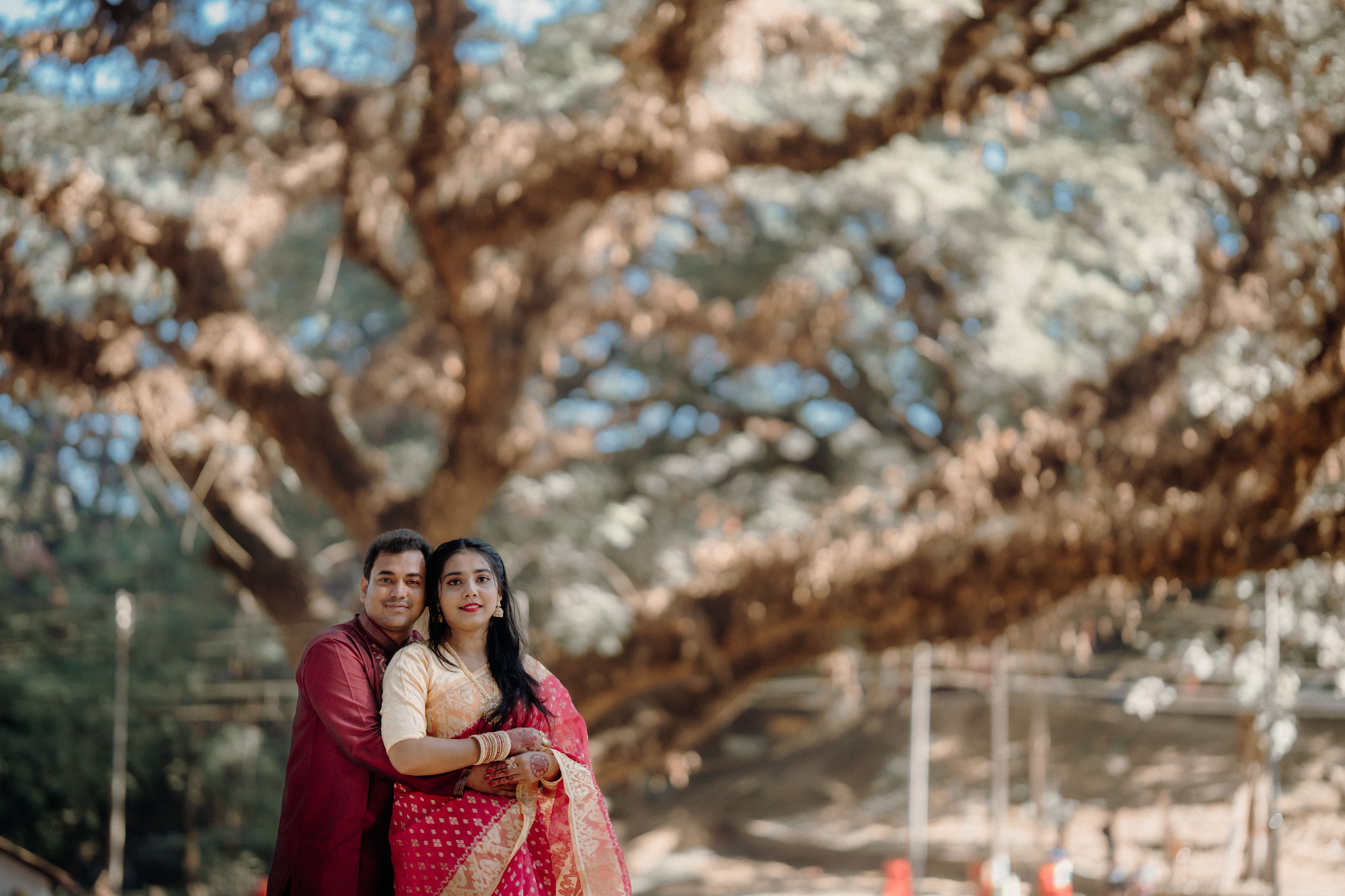 Romantic Couple Embracing Under Majestic Tree · Free Stock Photo