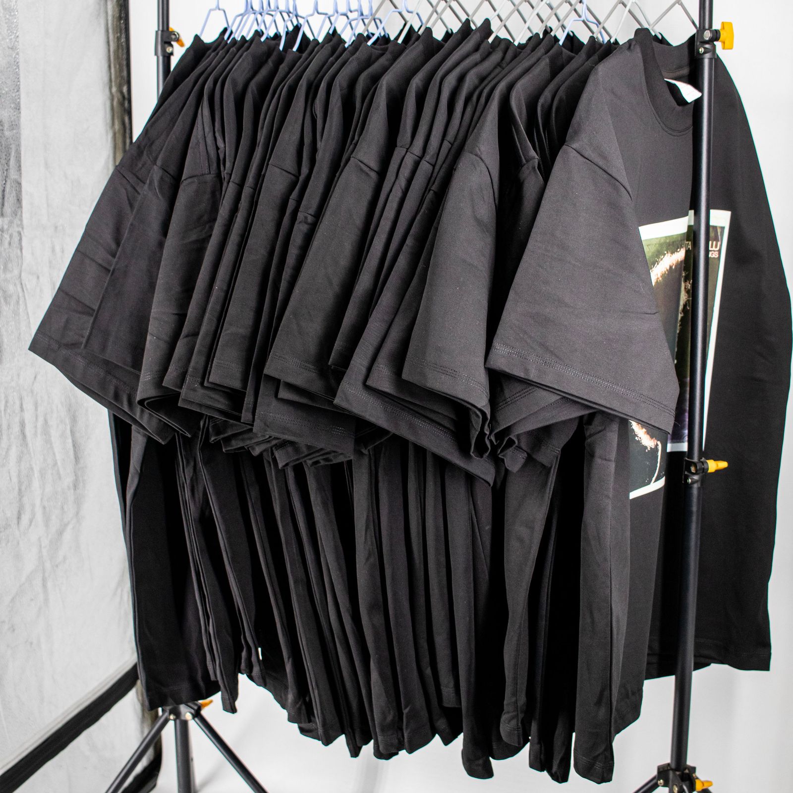 Plain black premium T-shirts arranged in a studio