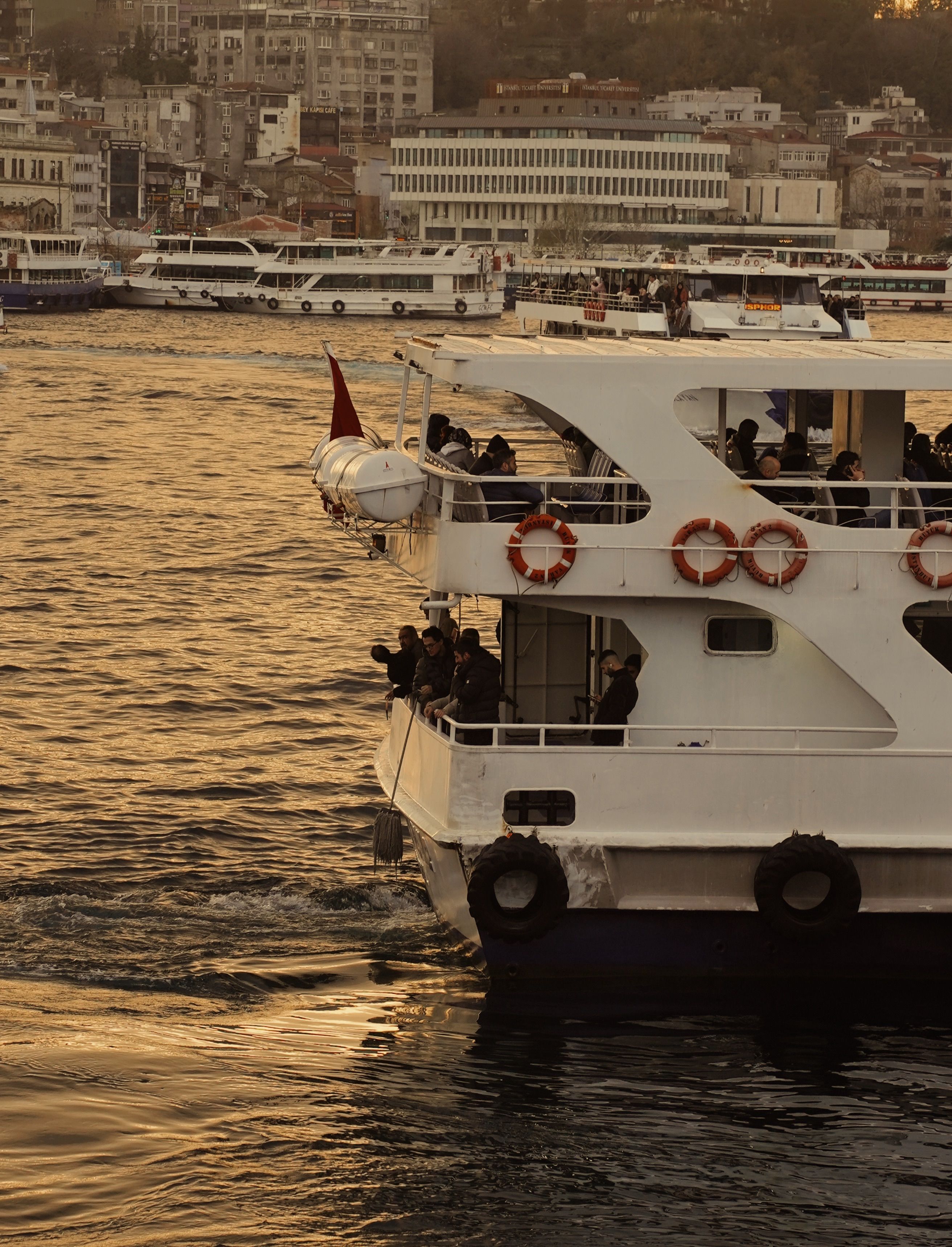 Scenic ferry ride at sunset over urban waterway · Free Stock Photo