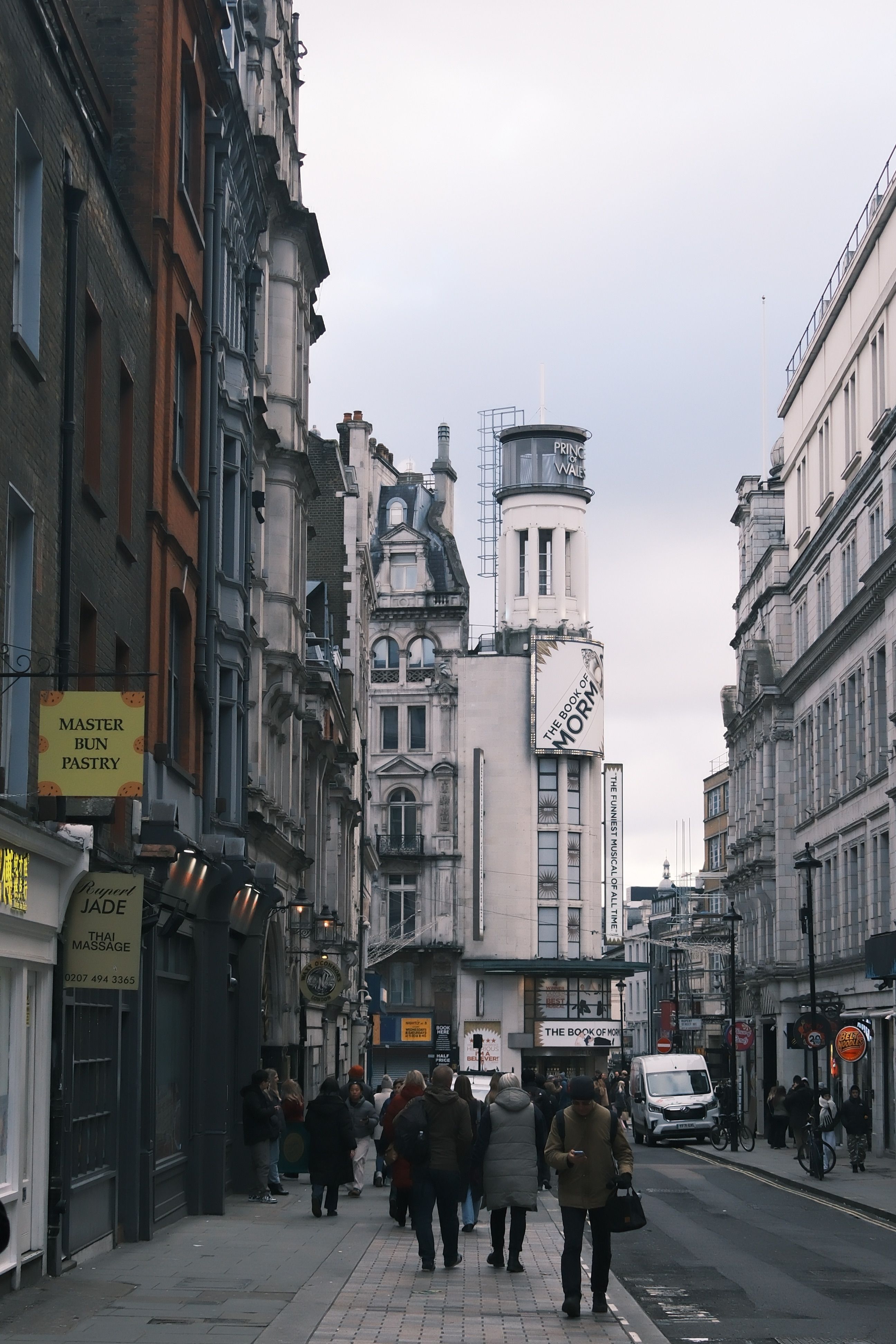 Urban street in London with iconic architecture and people walking.