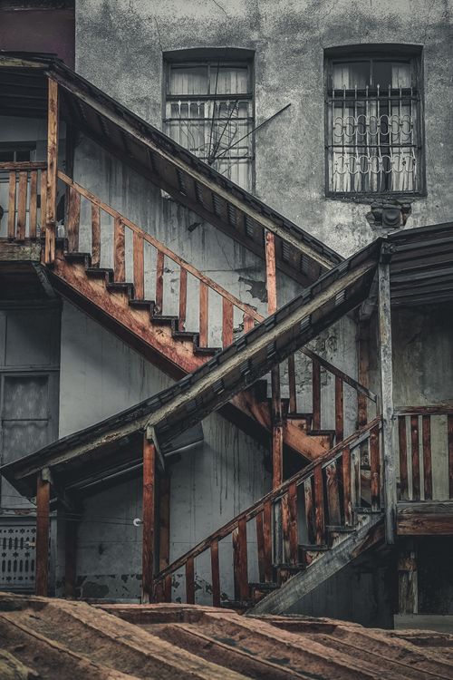 Free Rustic wooden stairs against weathered facade symbolize urban decay in Tbilisi, Georgia. Stock Photo