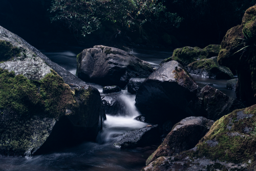 Free Peaceful waterfall cascading over moss-covered rocks in Quito, Ecuador. Stock Photo