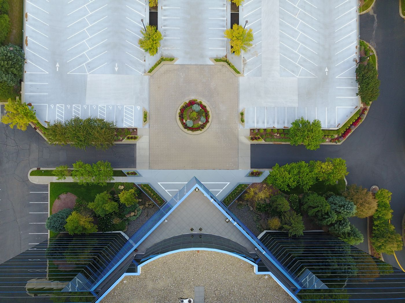 Top-down aerial view of a modern office building and parking area
