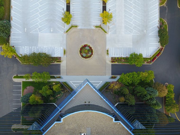 Top-down aerial view of a modern office building and parking area