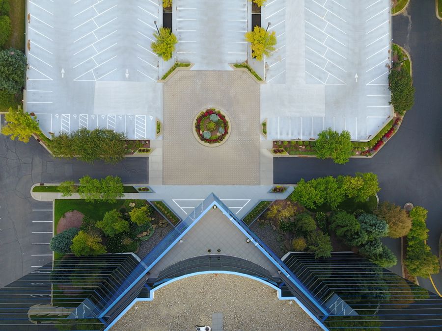 Top-down aerial view of a modern office building and parking area