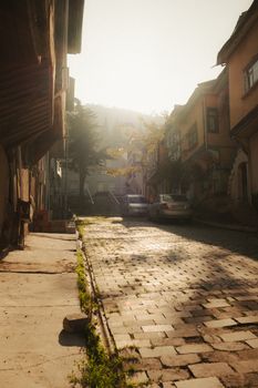 Cobblestone street in Afyonkarahisar, Türkiye, bathed in warm morning light.