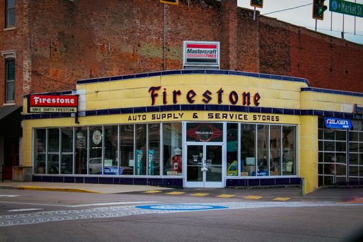 Vintage Firestone store in historic New Albany, featuring classic architecture.