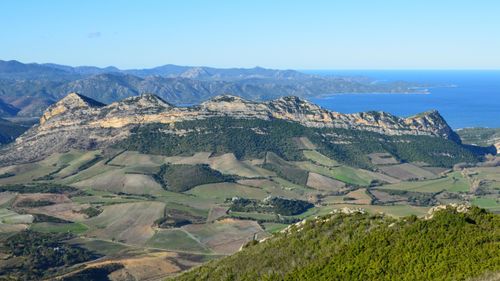 Free Scenic aerial view of Corsican landscape with mountains and coastline near Saint-Florent, France. Stock Photo