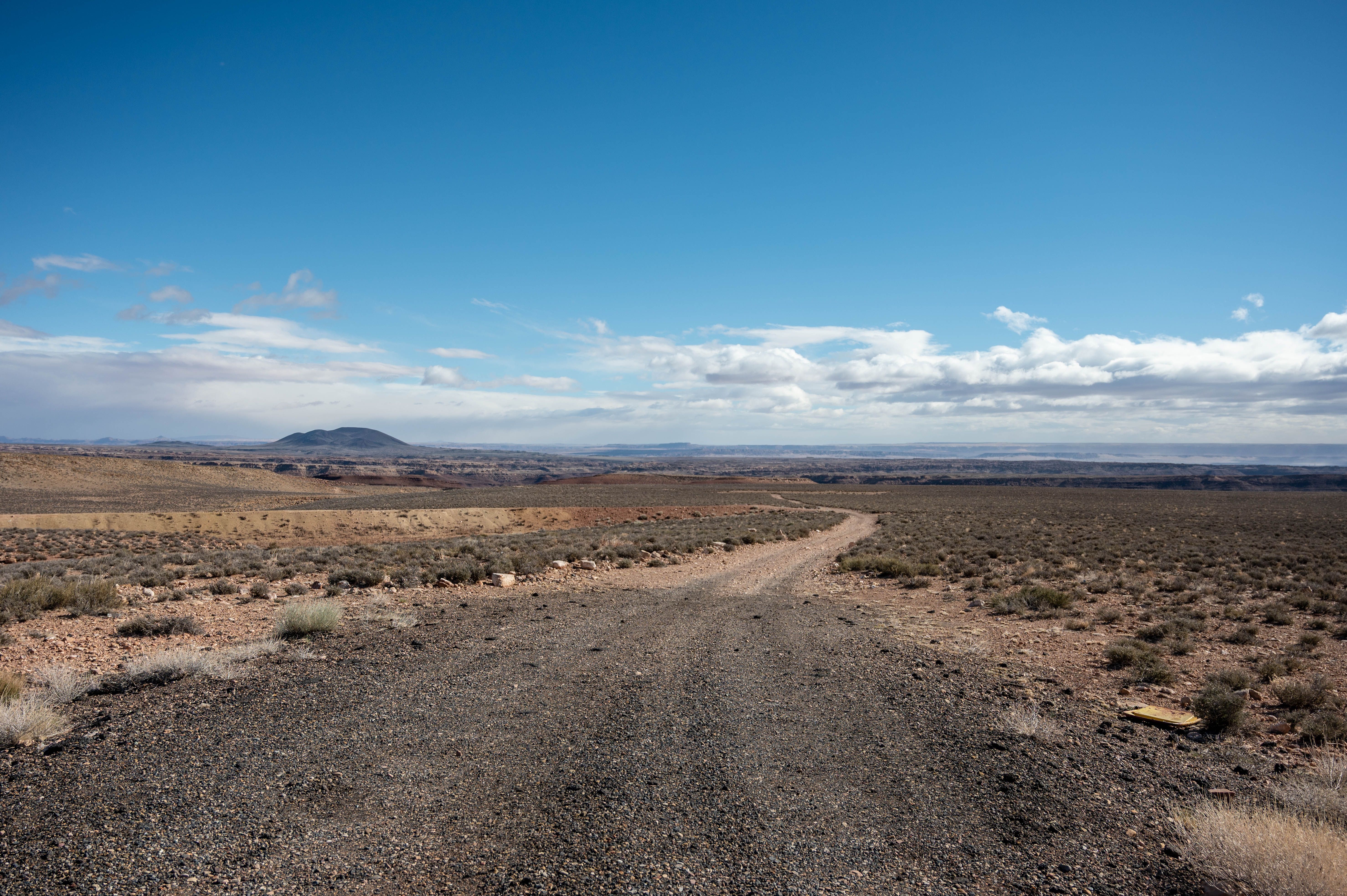 A vast desert scene featuring rugged terrain under a clear blue sky, ideal for travel and adventure themes.