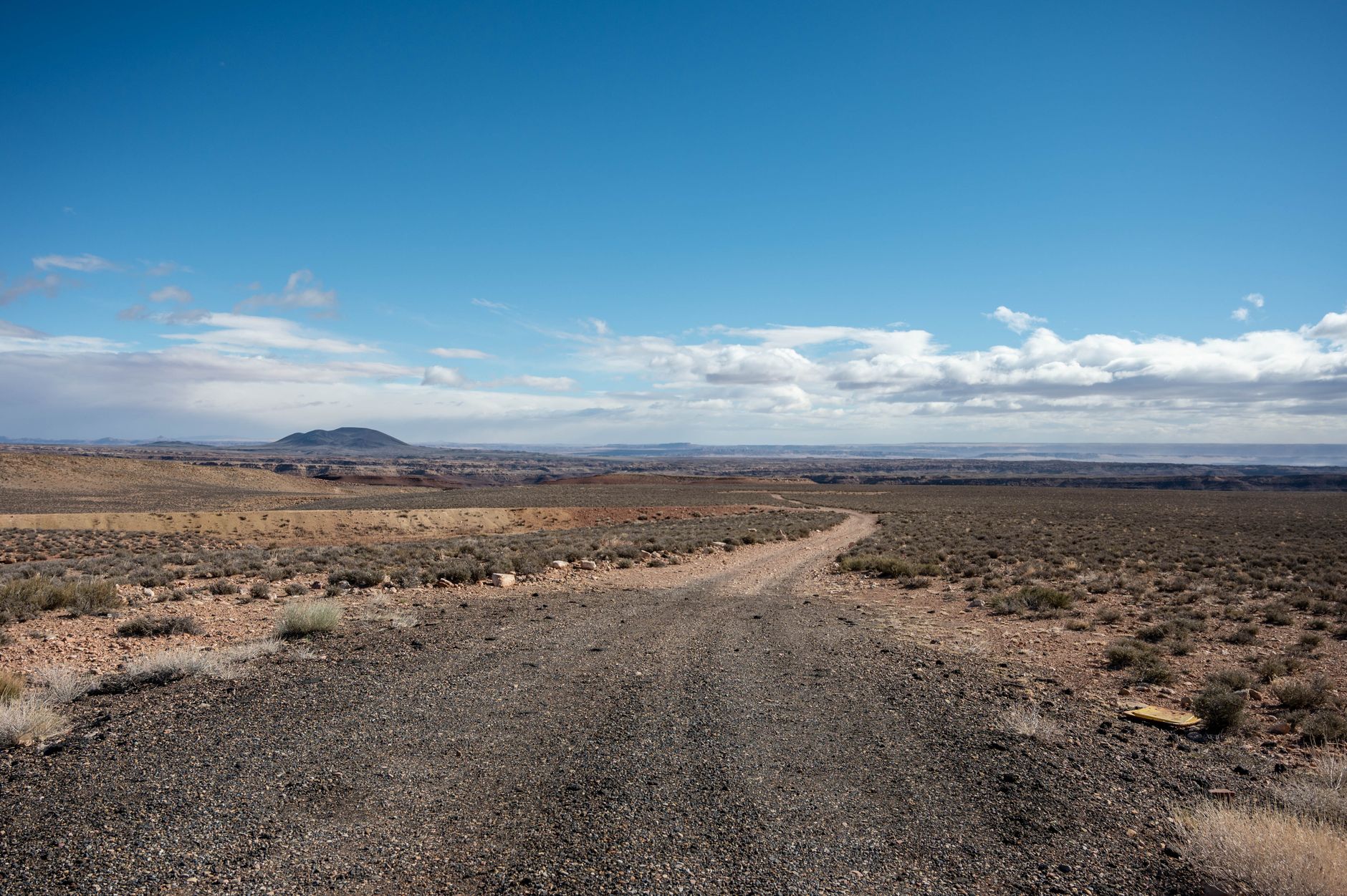 A vast desert scene featuring rugged terrain under a clear blue sky, ideal for travel and adventure themes.