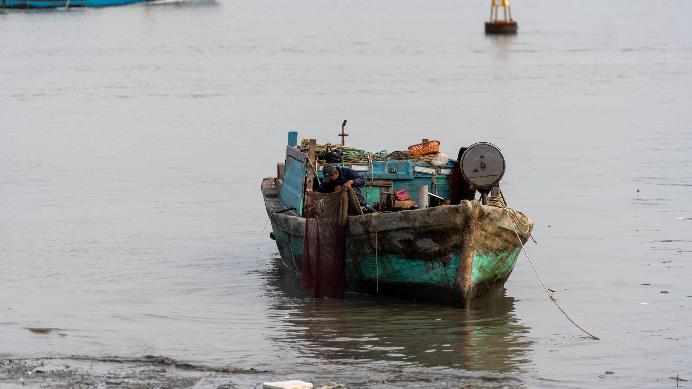 A rustic fishing boat anchored in Vũng Tàu, showcasing traditional Vietnamese maritime culture.