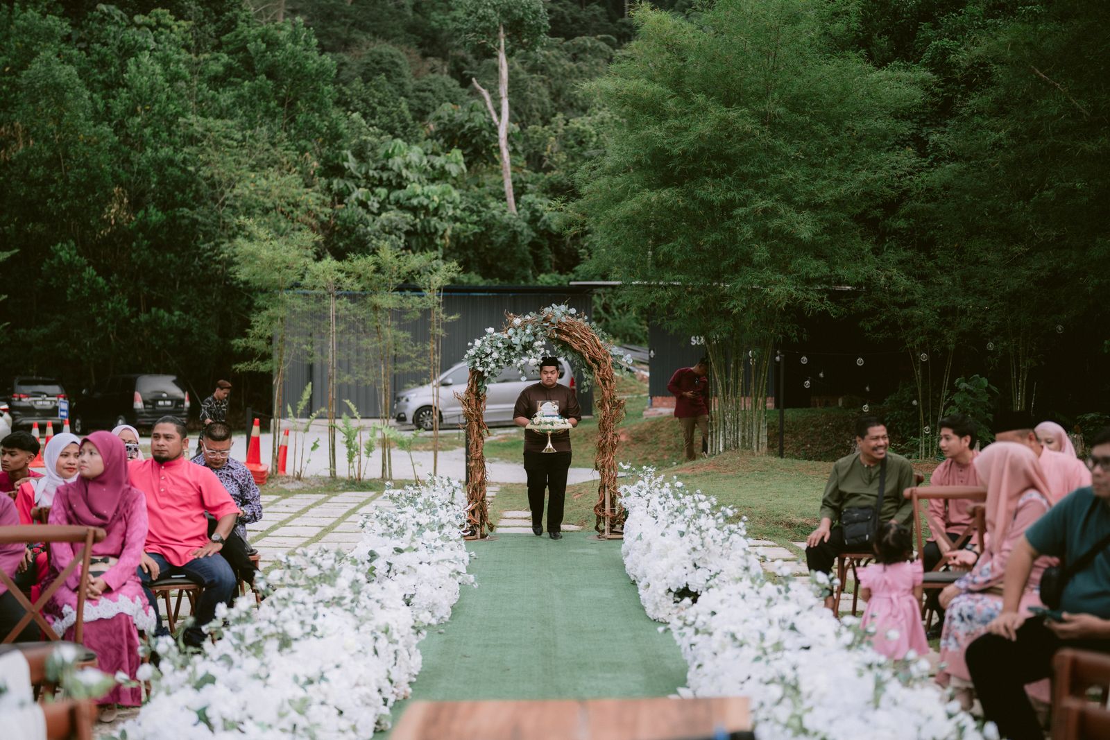 Outdoor wedding ceremony with seated guests and floral decor