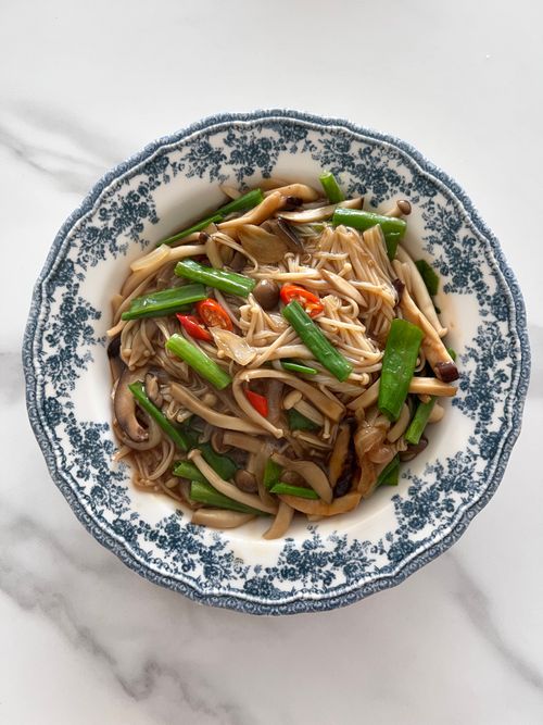 Free A close-up of a savory Asian mushroom stir-fry with vegetables served in a vintage porcelain bowl. Stock Photo