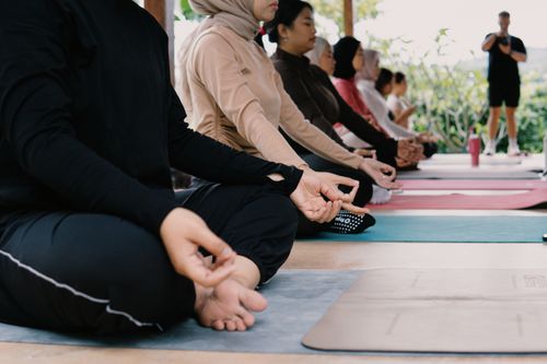 Free A diverse group practicing yoga outdoors in Jawa Barat, Indonesia. Relaxation and mindfulness in nature. Stock Photo