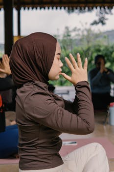 A woman practicing yoga in an outdoor setting in Jawa Barat, embracing mindfulness and tranquility.