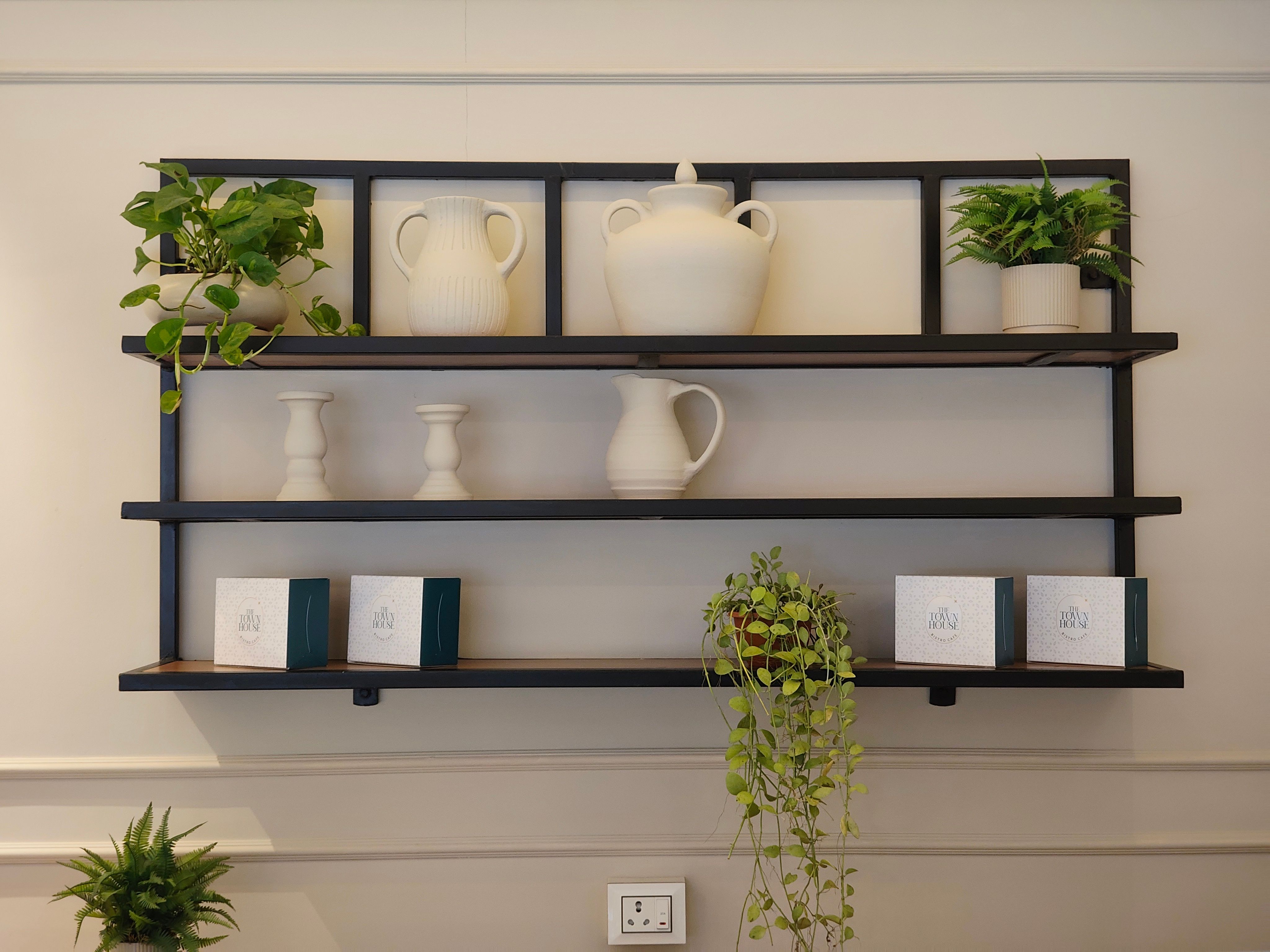 Minimalistic wall shelf in small apartment with compact storage