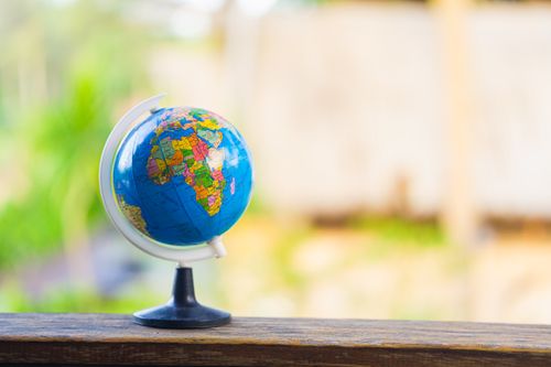 Free Vibrant globe resting on a wood ledge outdoors, highlighting Africa. Stock Photo