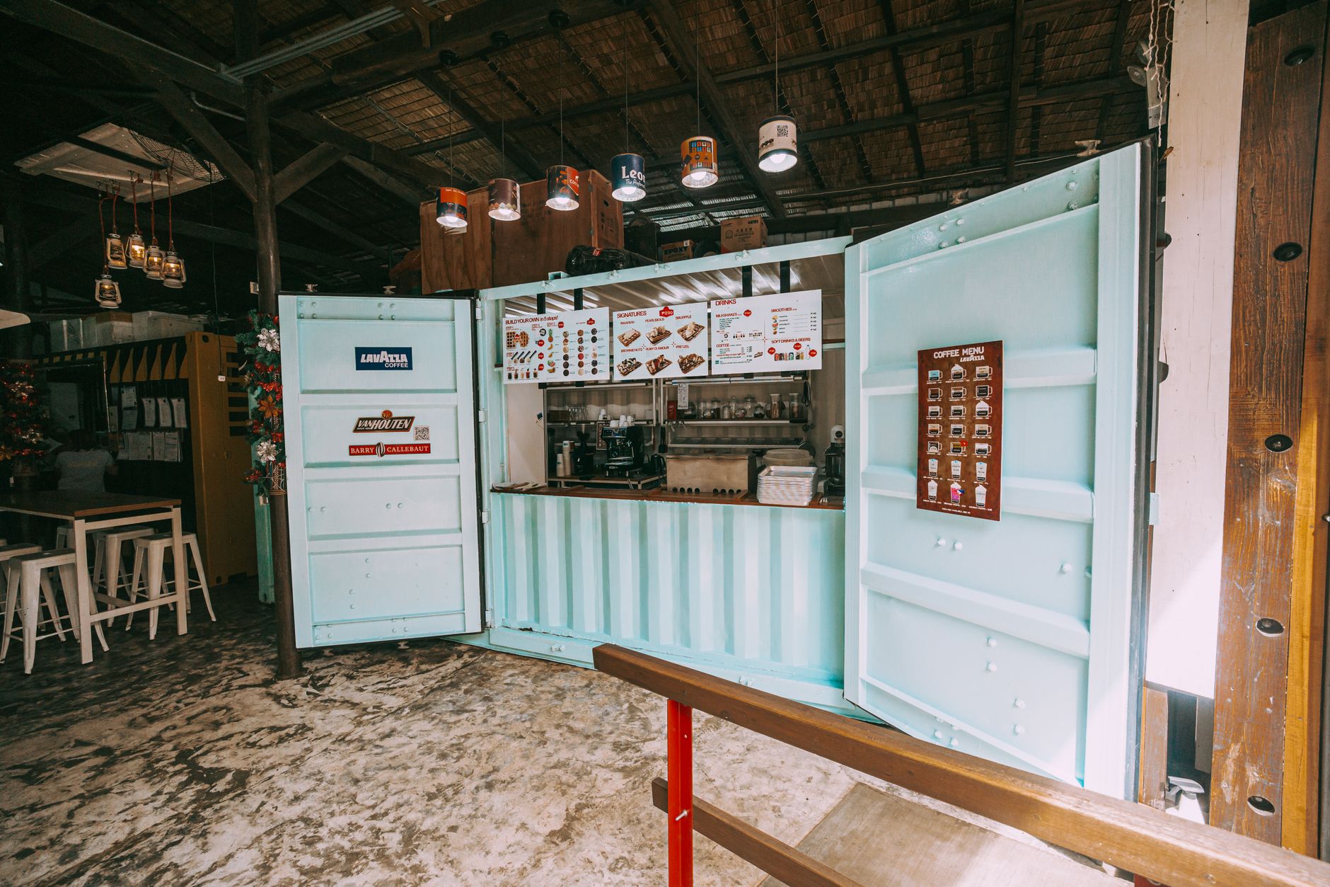 Repurposed shipping container as a trendy coffee bar with a rustic interior setting.