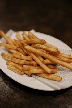 Delicious crispy golden French fries served on a plate in Tokyo, Japan. Perfect for fast food lovers.