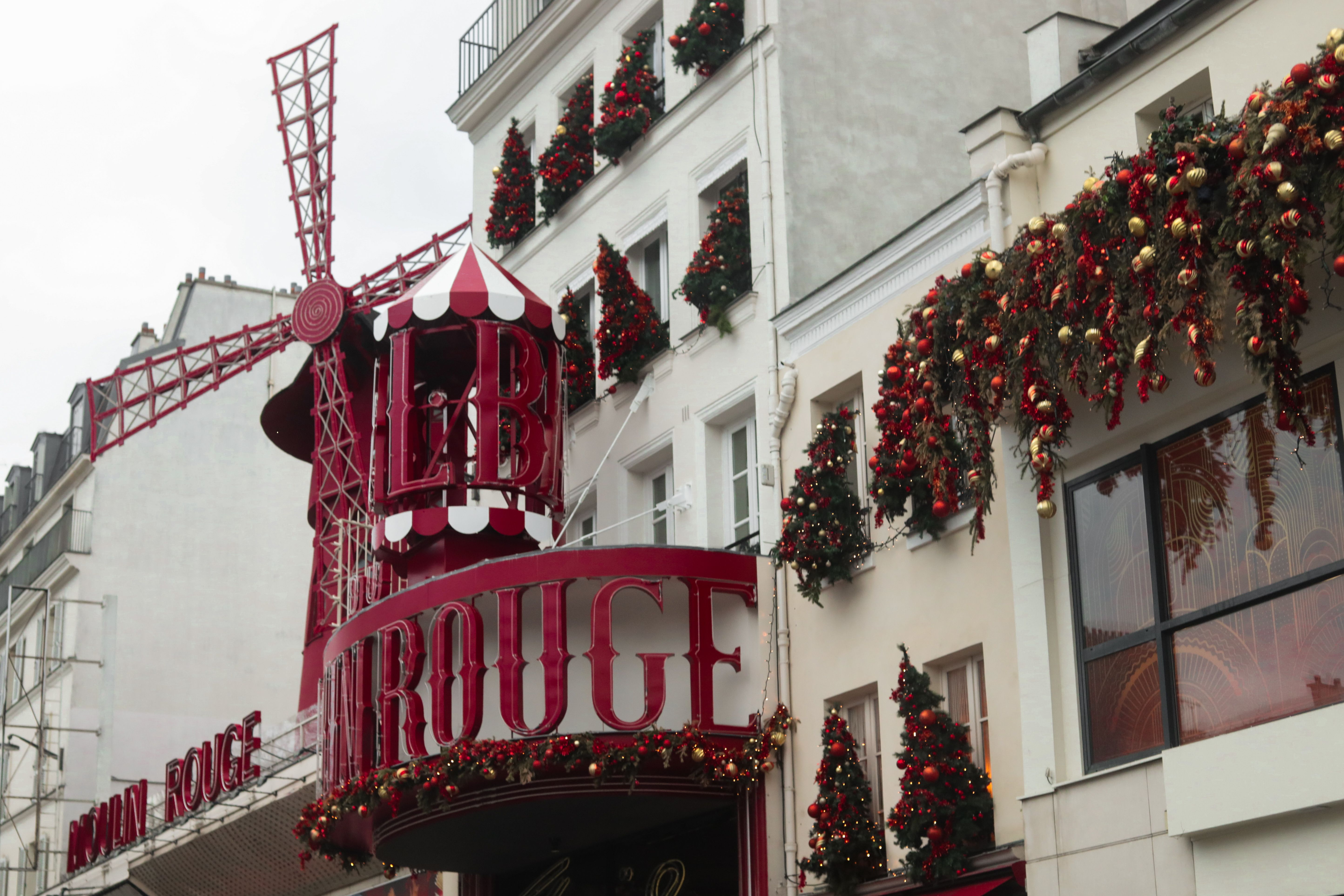 Moulin Rouge in Paris festively decorated with Christmas ornaments and red windmill.